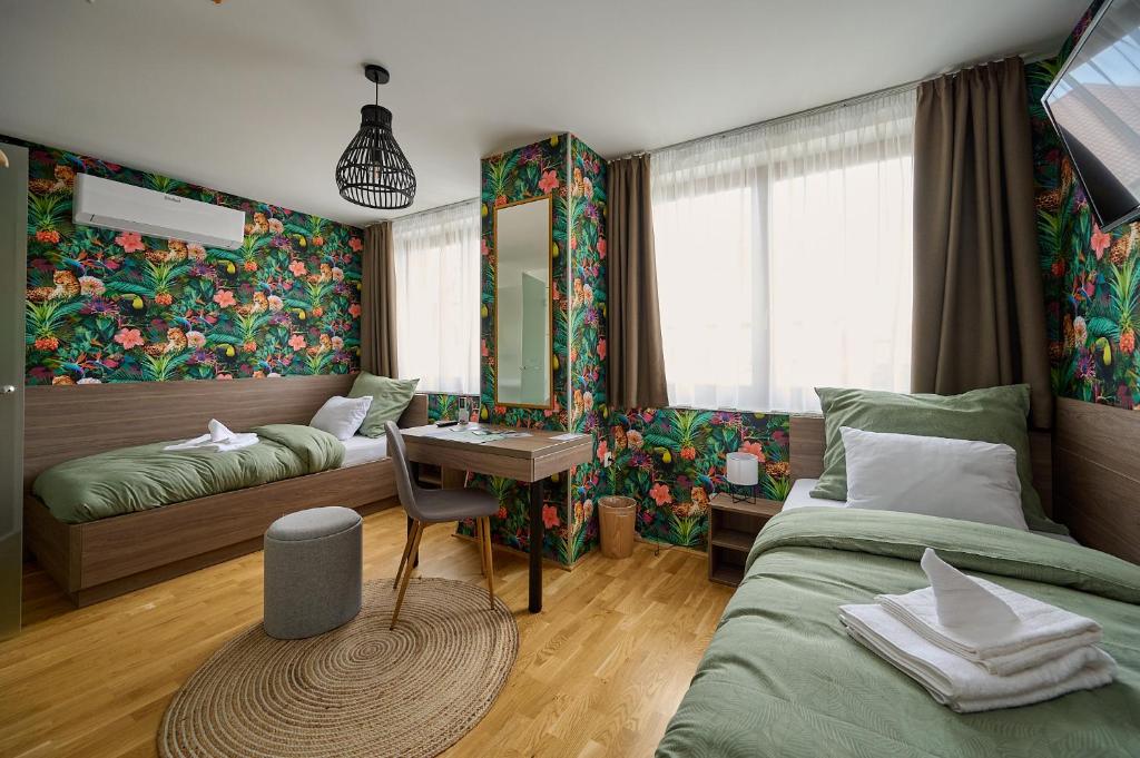 a bedroom with a bed and a desk in it at ROOMS in Szombathely