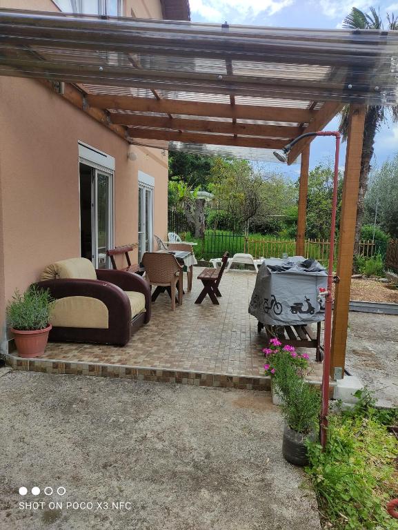 a patio with a pergola and a grill at Villa Helen in Donji Stoliv