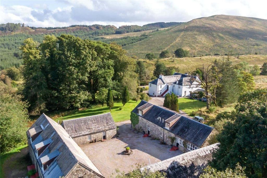 an aerial view of a house in the hills at Killean Farmhouse Cottages 