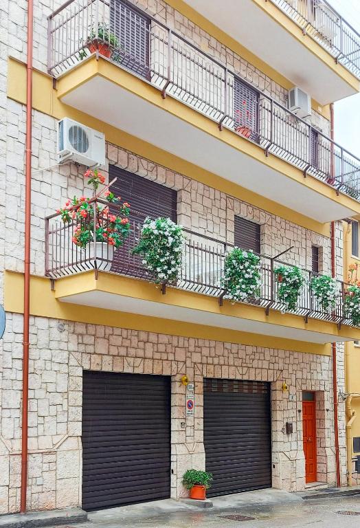 a building with two garage doors and two balconies at L'angolo di Rosa in Campofelice di Roccella