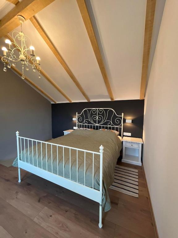 a bedroom with a white bed and a chandelier at Apartment and Studio Ivan Dolac in Ivan Dolac