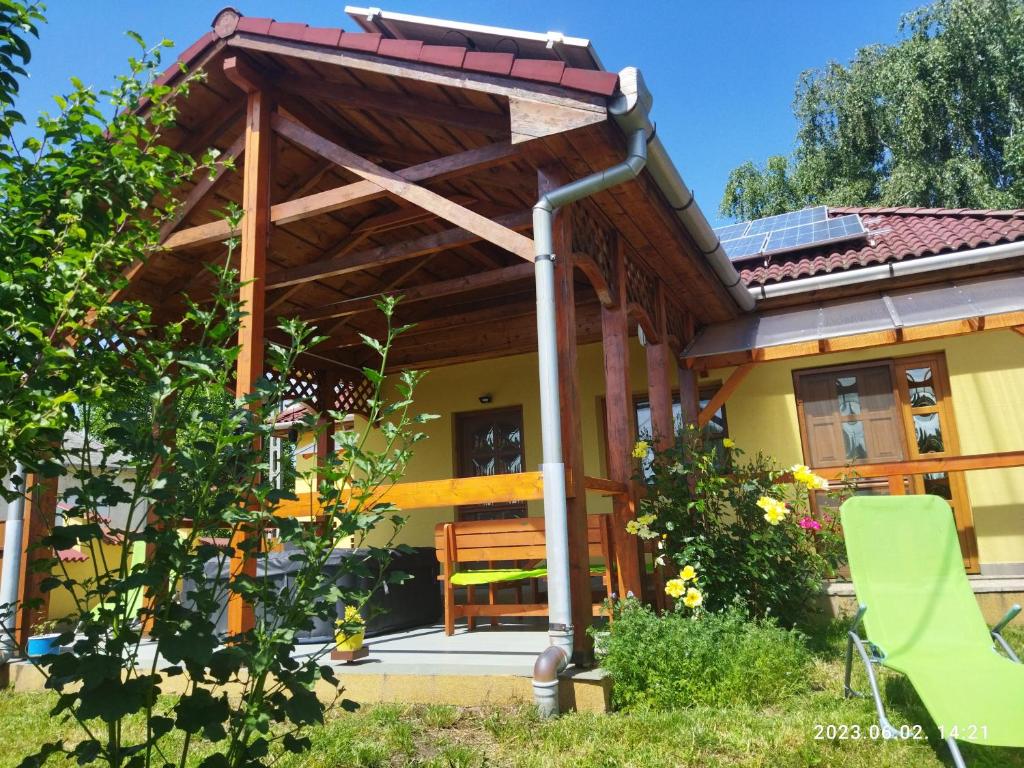 a porch of a house with a wooden pergola at Éden Vendégház in Kisnána