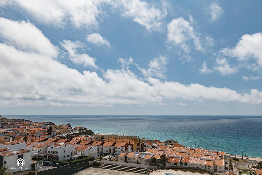 a view of a city and the ocean at Ondas do Pisão Apartment - 2 bedroom and Sea View in Santa Cruz