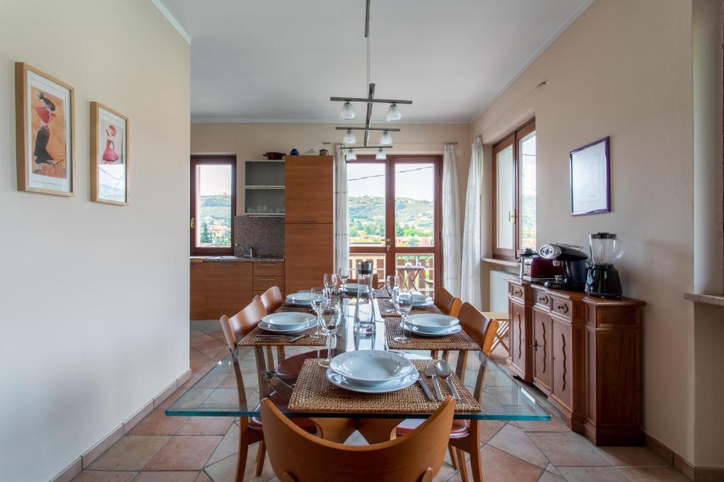 a dining room with a long table and chairs at Family Home - Garda 3 bedrooms apartment in Garda