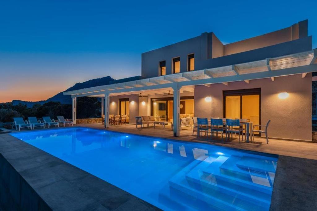 a villa with a swimming pool at night at Solis Lindos Villa in Lindos