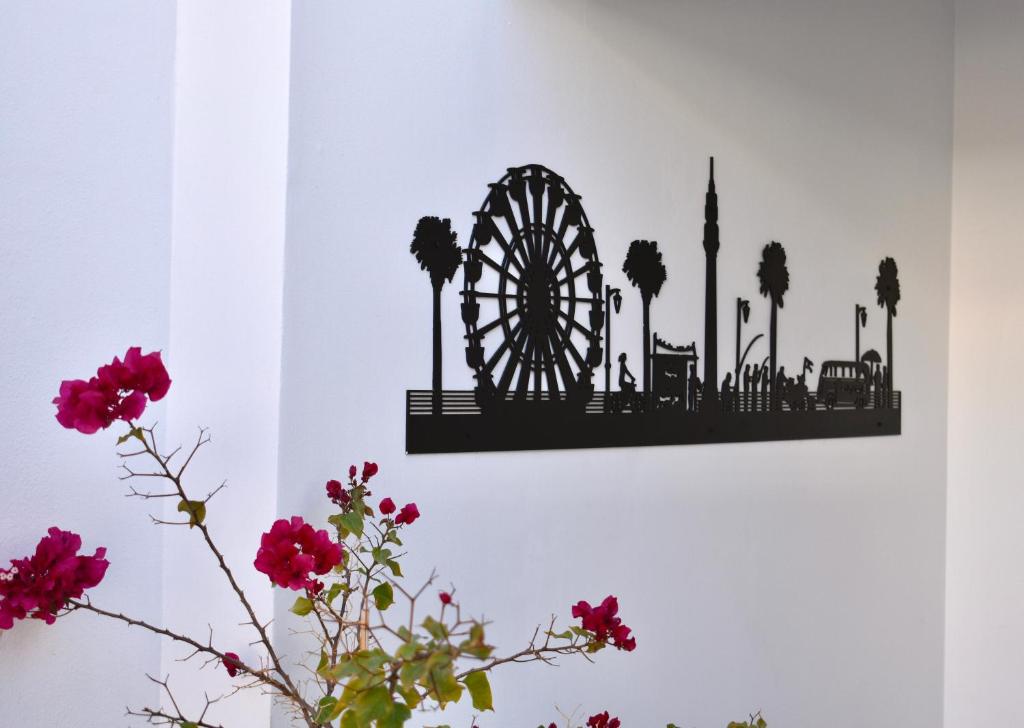 a black silhouette of a ferris wheel on a wall at Zoi Ayia Napa in Ayia Napa