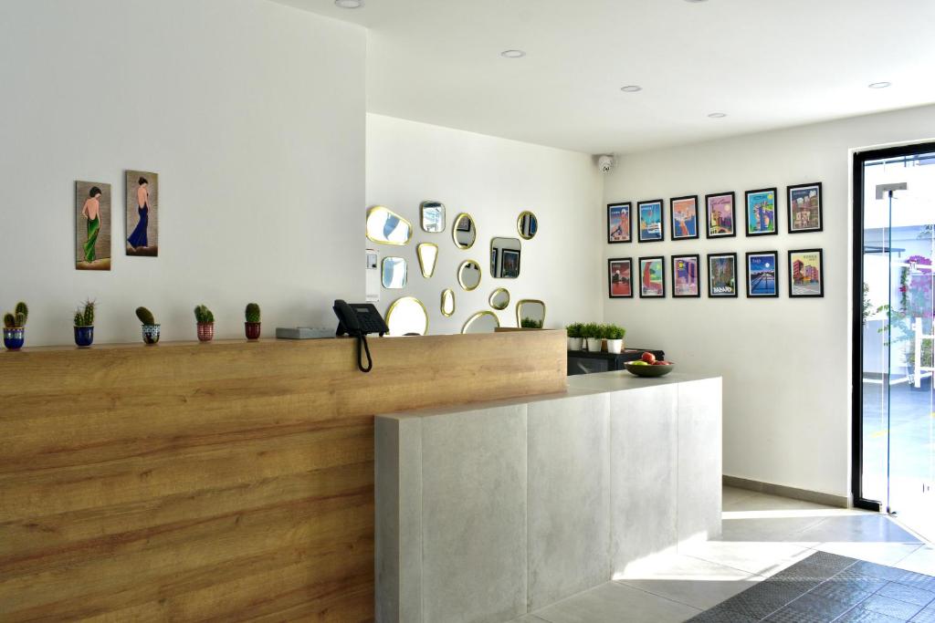 a lobby of a store with paintings on the wall at Zoi Ayia Napa in Ayia Napa