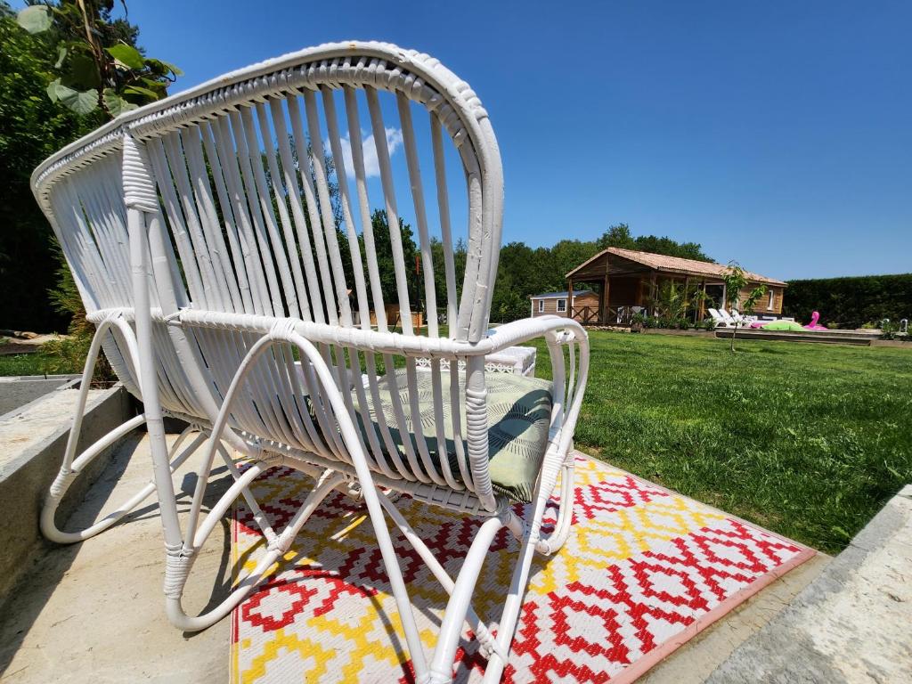 a white rocking chair sitting on a blanket at Le clos de lignac in Cieux