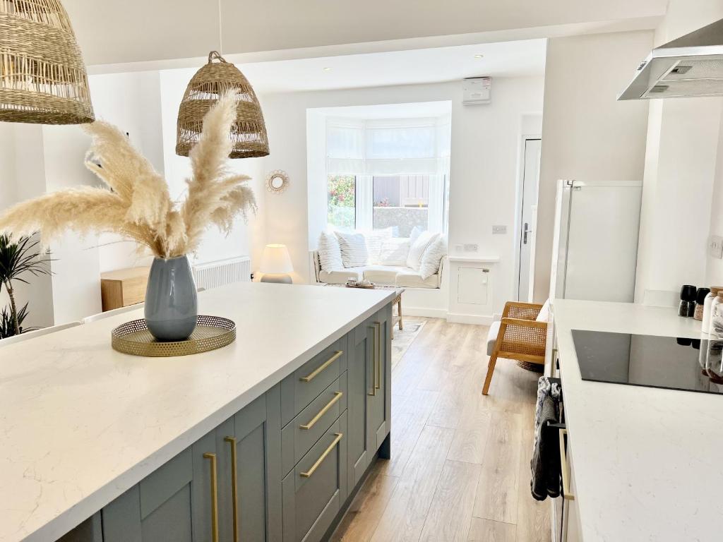 a kitchen with a island with a vase with a plant at 2 Edward Street in Llandudno