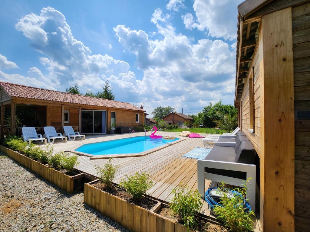 a backyard with a swimming pool and a house at Le clos de lignac in Cieux