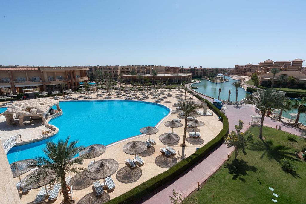 an aerial view of a resort swimming pool with umbrellas at Parrotel Lagoon Waterpark Resort in Sharm El Sheikh