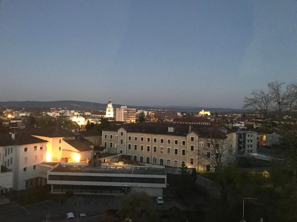 a view of a city at night with buildings at Bel appartement rénové, spacieux et lumineux in Bourg-en-Bresse