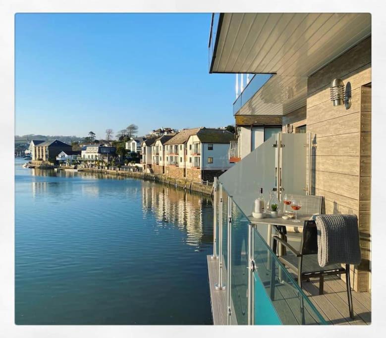 a balcony with a view of a body of water at 3 The Boatyard - Luxurious waterside 4 bed townhouse, lift, parking in Kingsbridge