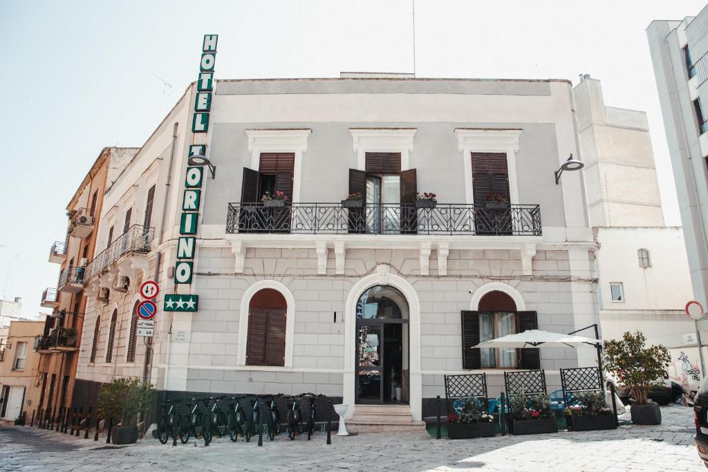 a building with a sign on the side of it at Hotel Torino in Brindisi