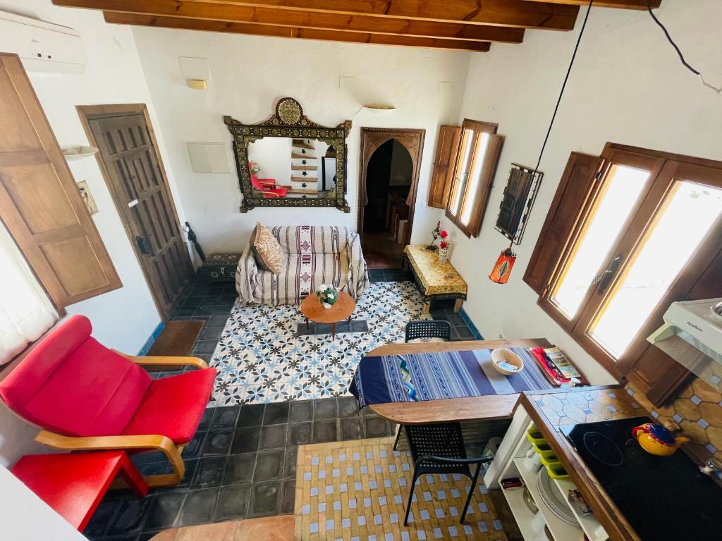 an aerial view of a living room with red chairs and a table at Casa Patio de Monjas in Vejer de la Frontera