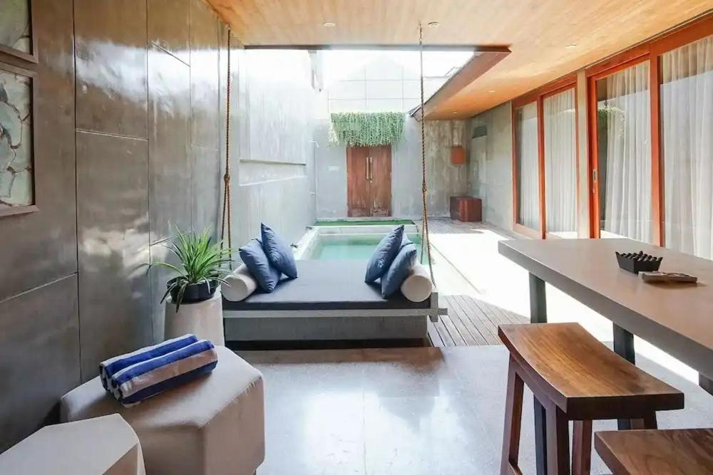 a room with a swinging bed in a house at Aqilah Villa Bali in Legian
