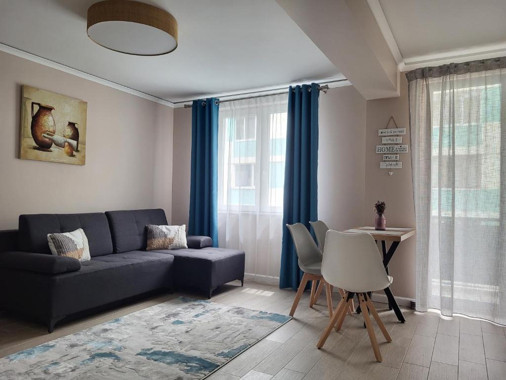 a living room with a couch and a table at Pandora Central Apartment in Cluj-Napoca