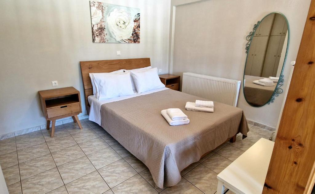a hotel room with a bed and a mirror at Primavera Apartment in Pilaroú