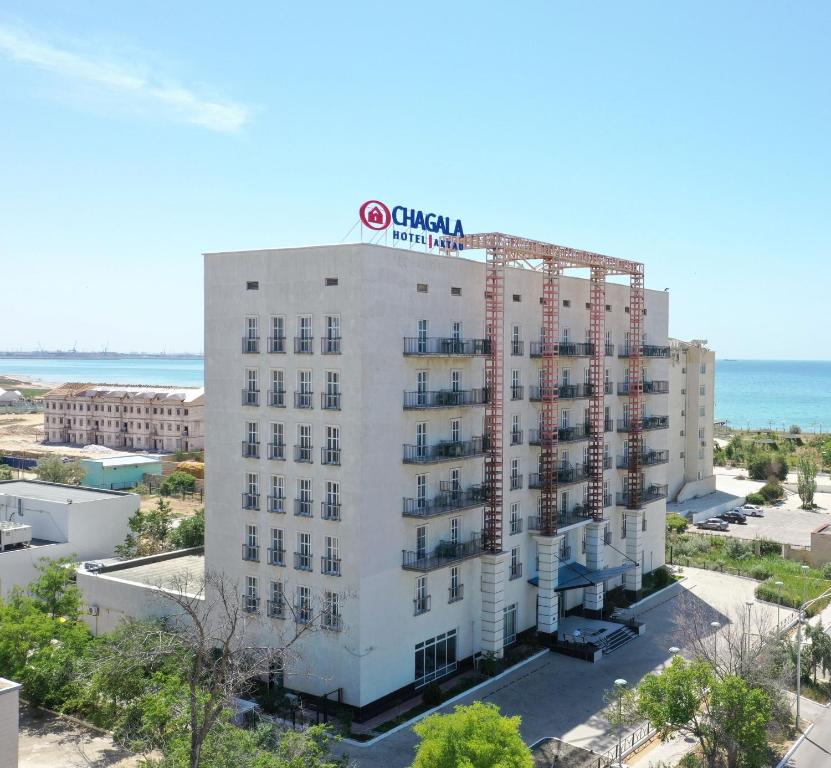 an aerial view of a hotel with the ocean in the background at Chagala Aktau Hotel in Aktau