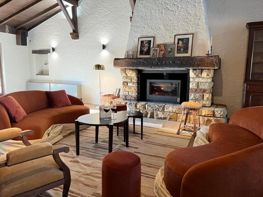 a living room with two couches and a fireplace at Relais Manderen in Manderen