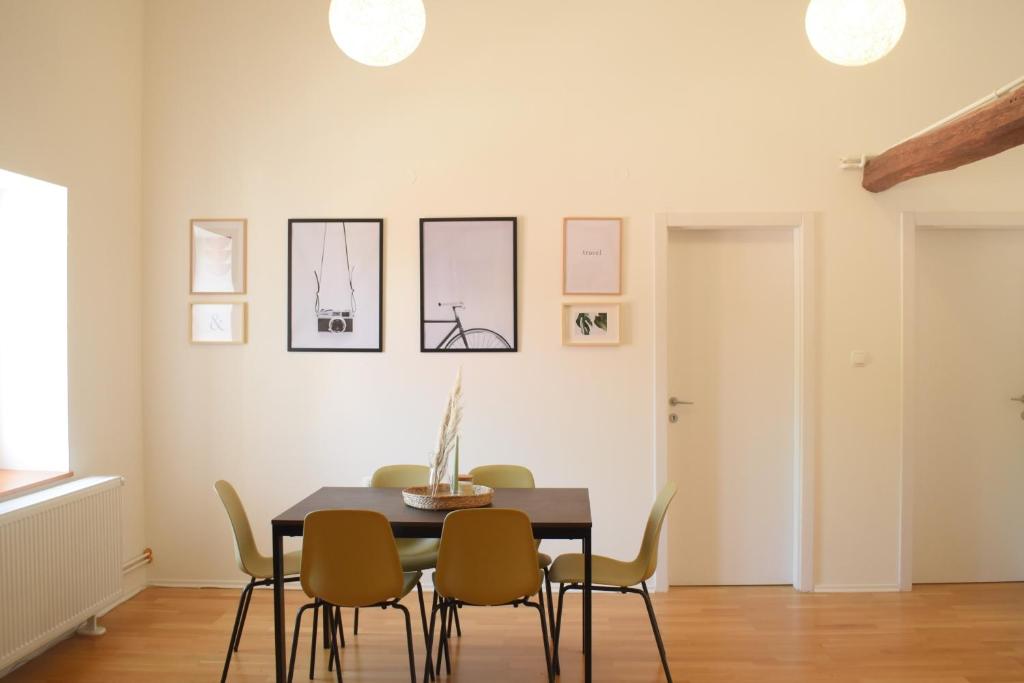 a dining room with a table and chairs at Central Park Apartments in Koprivnica