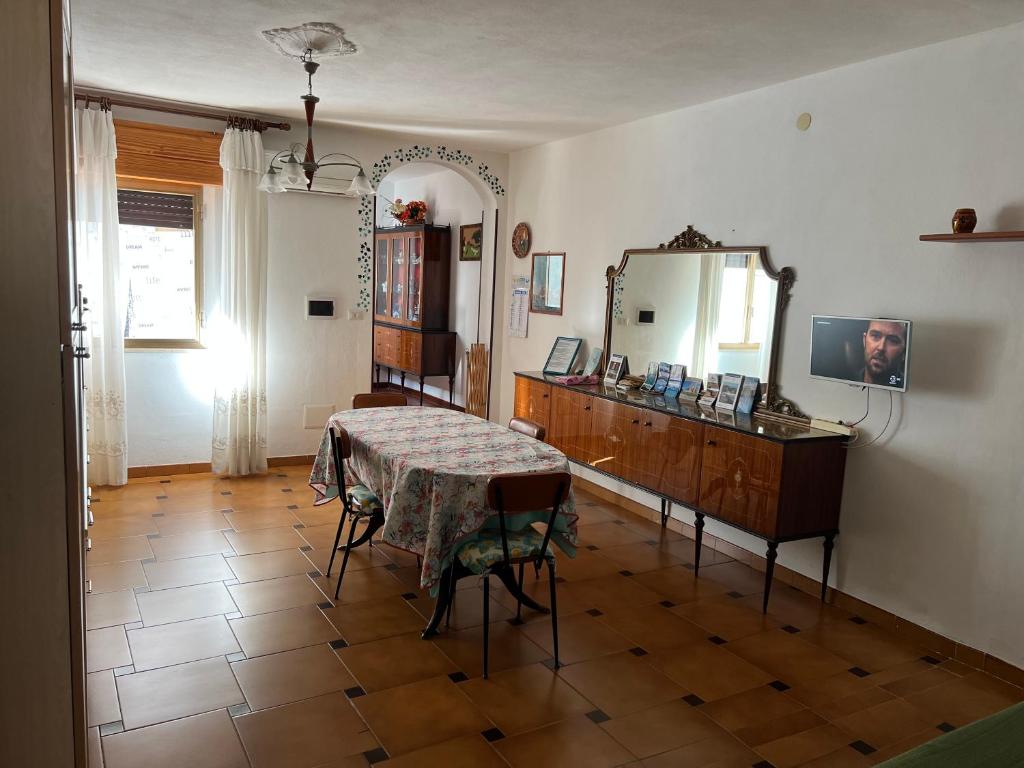 a dining room with a table and a mirror at Casa al Mare in Buggerru