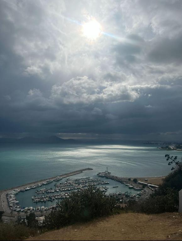 a view of a body of water with the sun at Studio El Jamil in Douar el Hafey