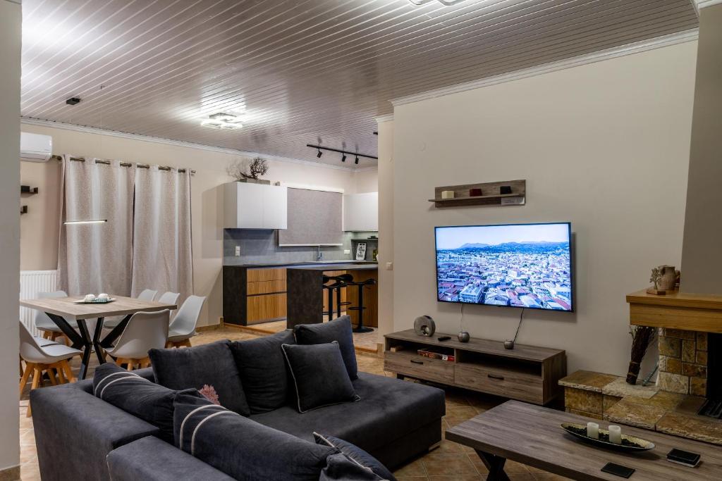 a living room with a couch and a flat screen tv at G.R luxury apartment in Lefkada Town