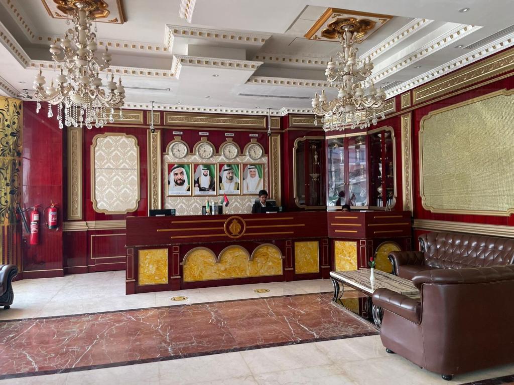 a living room with a couch and chandeliers at Clifton International Hotel in Fujairah