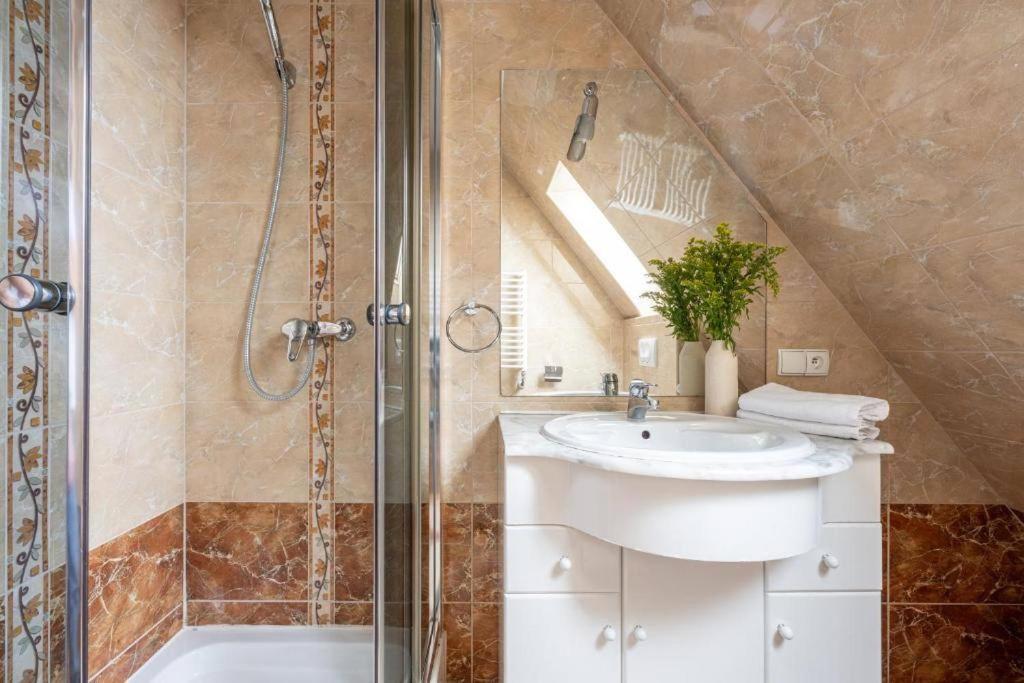 a bathroom with a sink and a shower at Apartament Centrum Zakopane in Zakopane