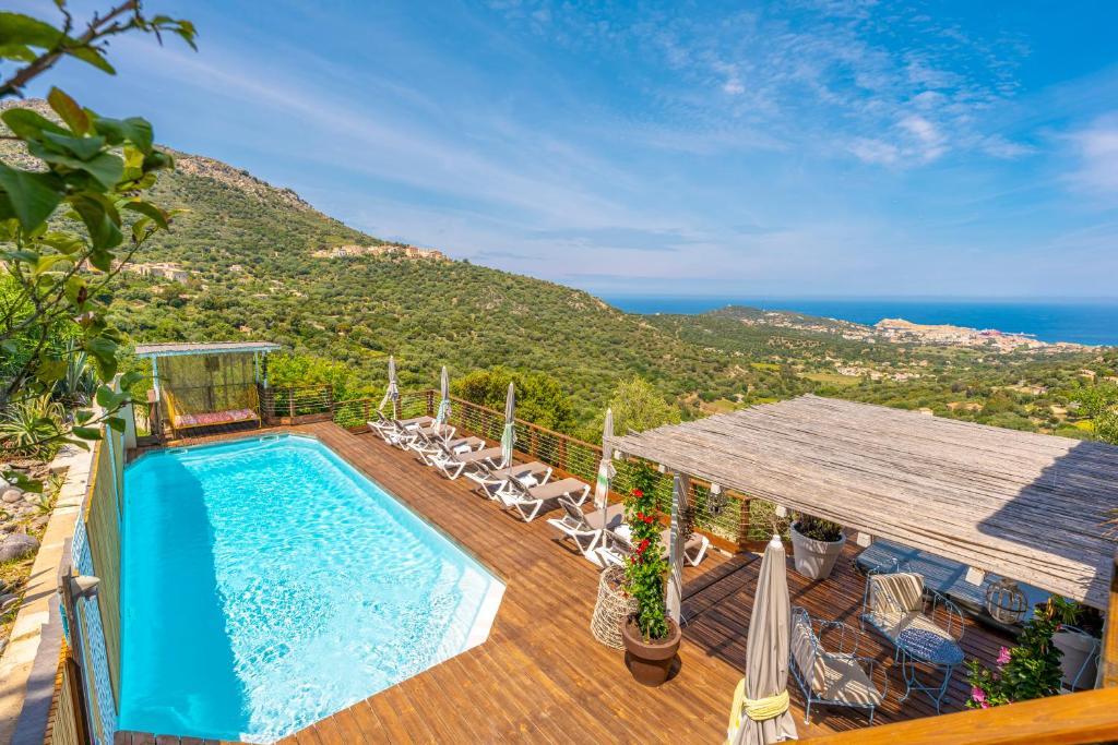 a pool on a deck with a view of the ocean at Domaine Bagia Donne in Santa-Reparata-di-Balagna