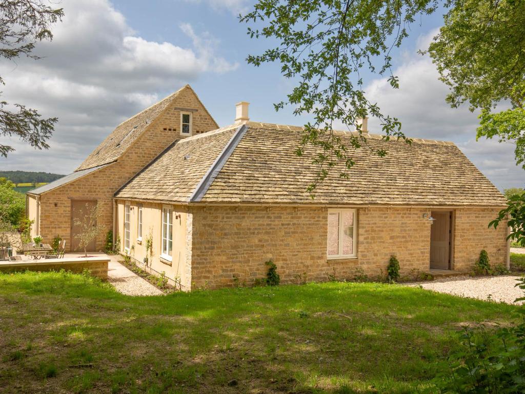a brick house with a gambrel roof at The Fold in Charlbury
