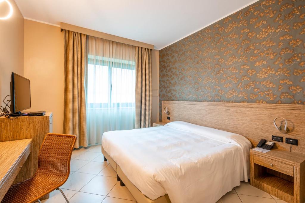 Postel nebo postele na pokoji v ubytování Hotel Parisi