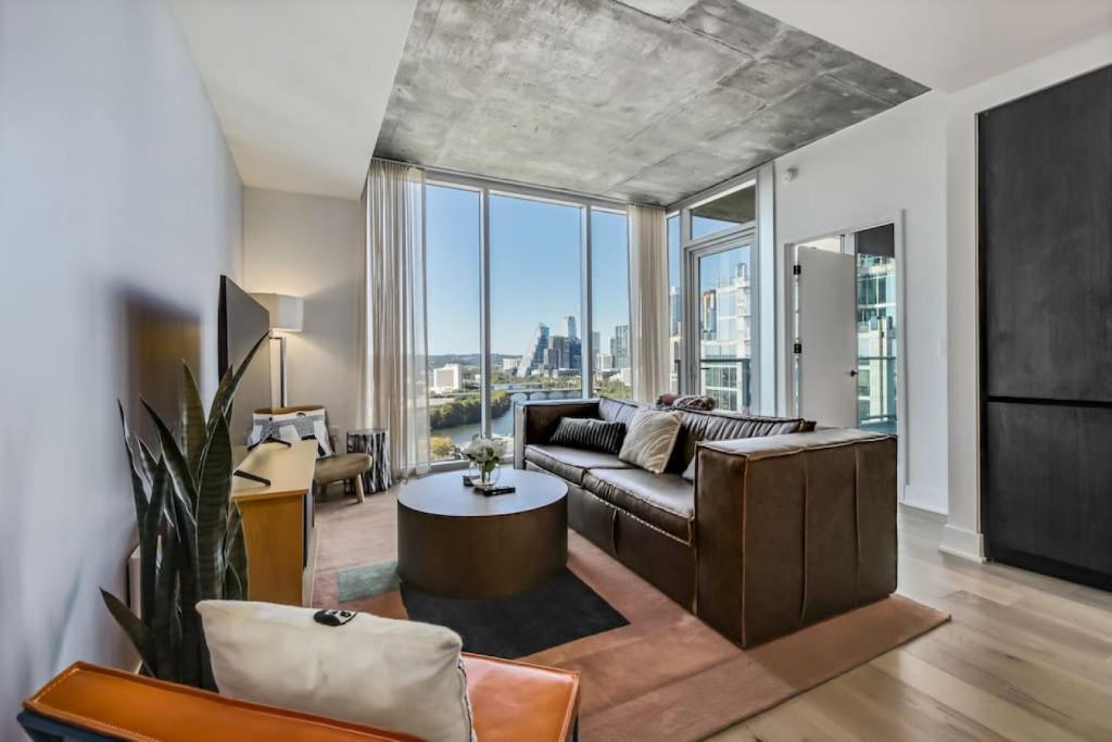 a living room with a couch and a table at 21st FL 2BD Condo-Rainey St-Best views in Austin