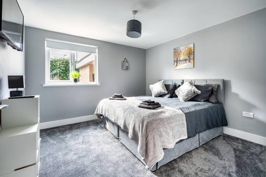 a bedroom with a bed and a window at Hudson Apartment in East Kilbride