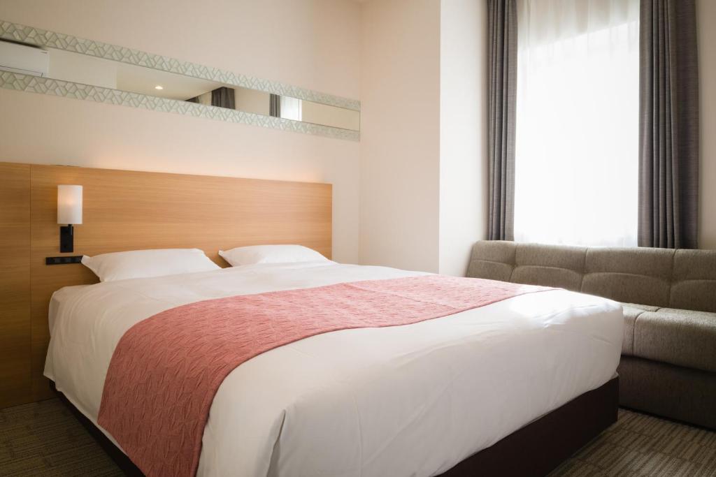 Tosei Hotel Cocone Ueno房間的床