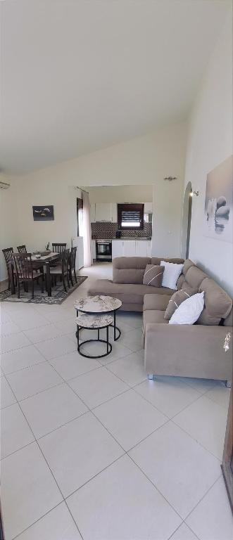 a living room with a couch and a table at Anna Maria Apartment in Skala Marion