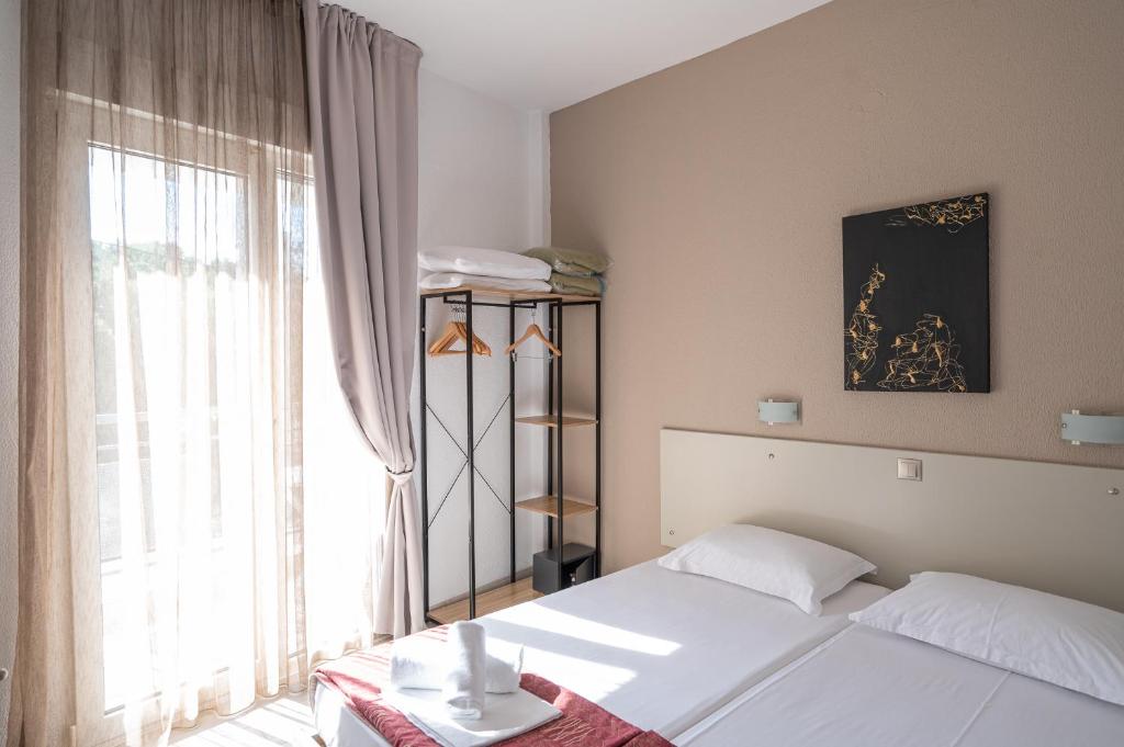 Postel nebo postele na pokoji v ubytování Hotel Akropol