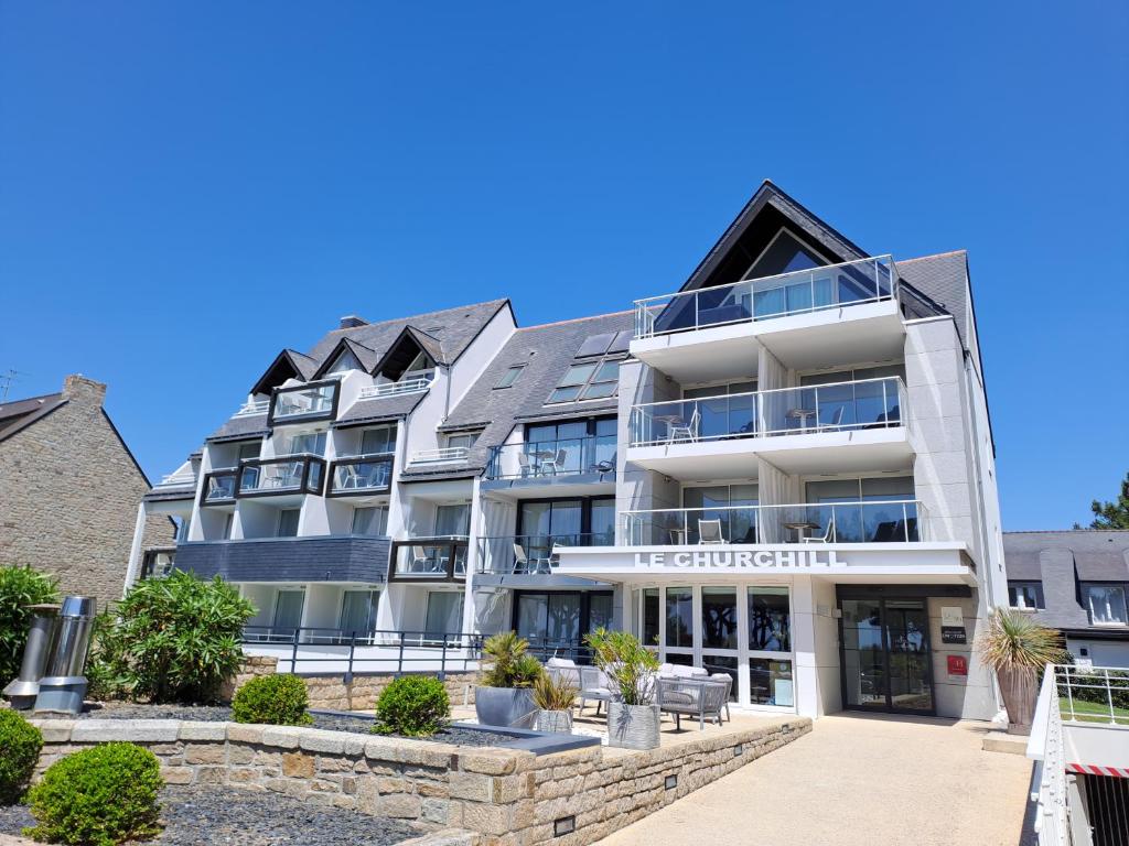 an apartment building with the front of it at Le Churchill Hôtel & Spa in Carnac