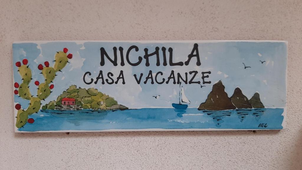 a sign on a wall that reads michilia casa valanca at Nichila - Casa Vacanze acitrezza in Acitrezza