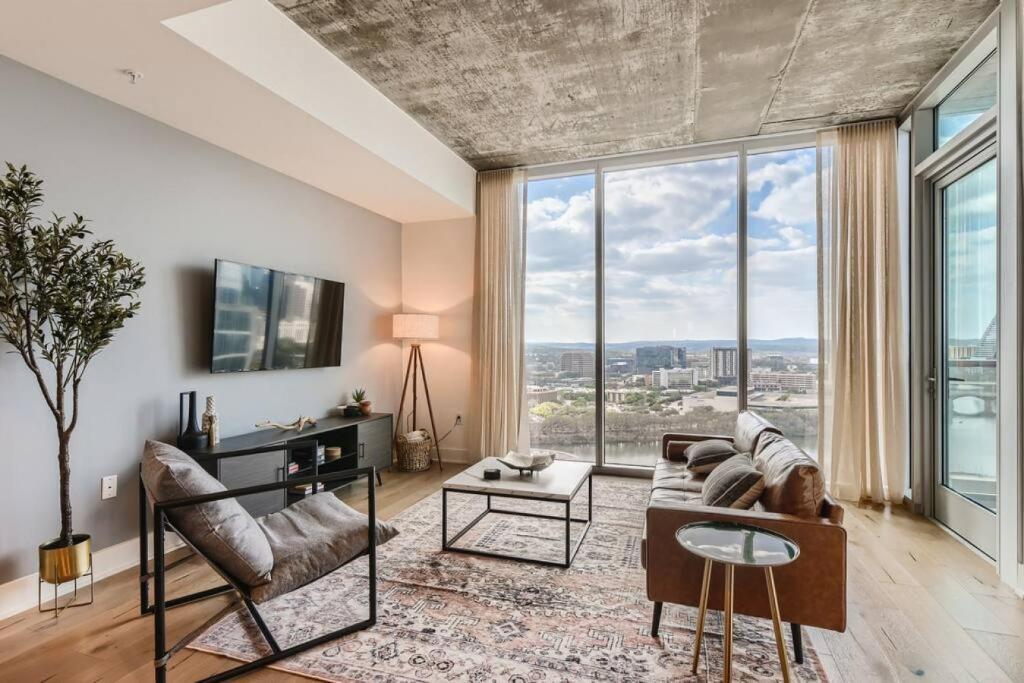 uma sala de estar com um sofá e uma grande janela em Incredible View Of Downtown Walk To Rainey St em Austin