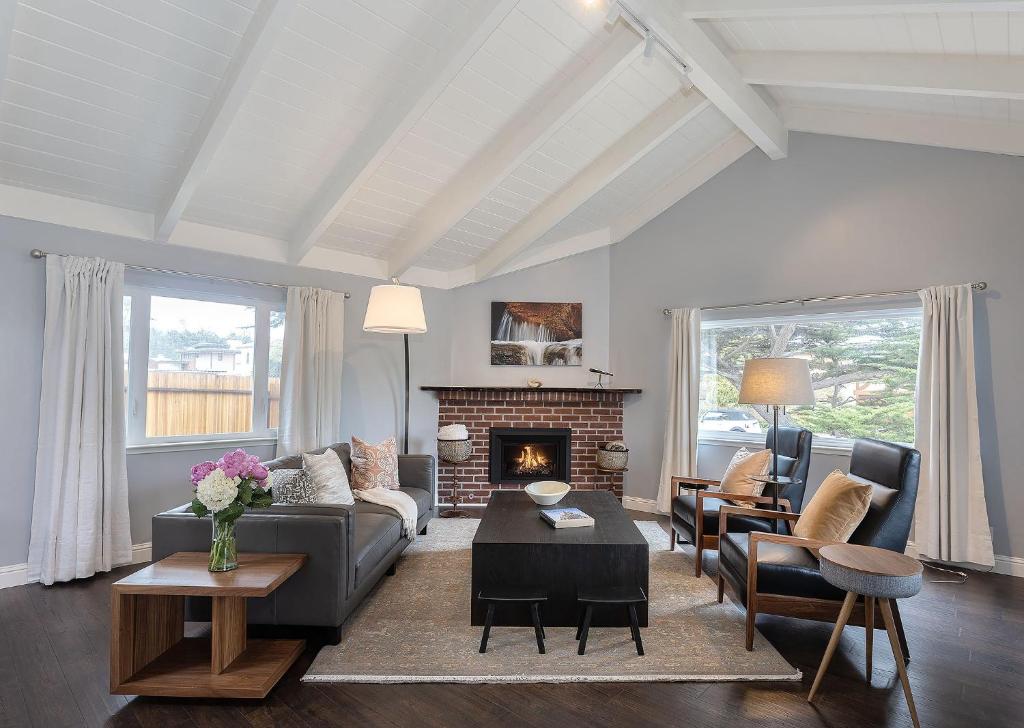 a living room with a couch and a fireplace at 3890 Cypress Rest home in Pebble Beach