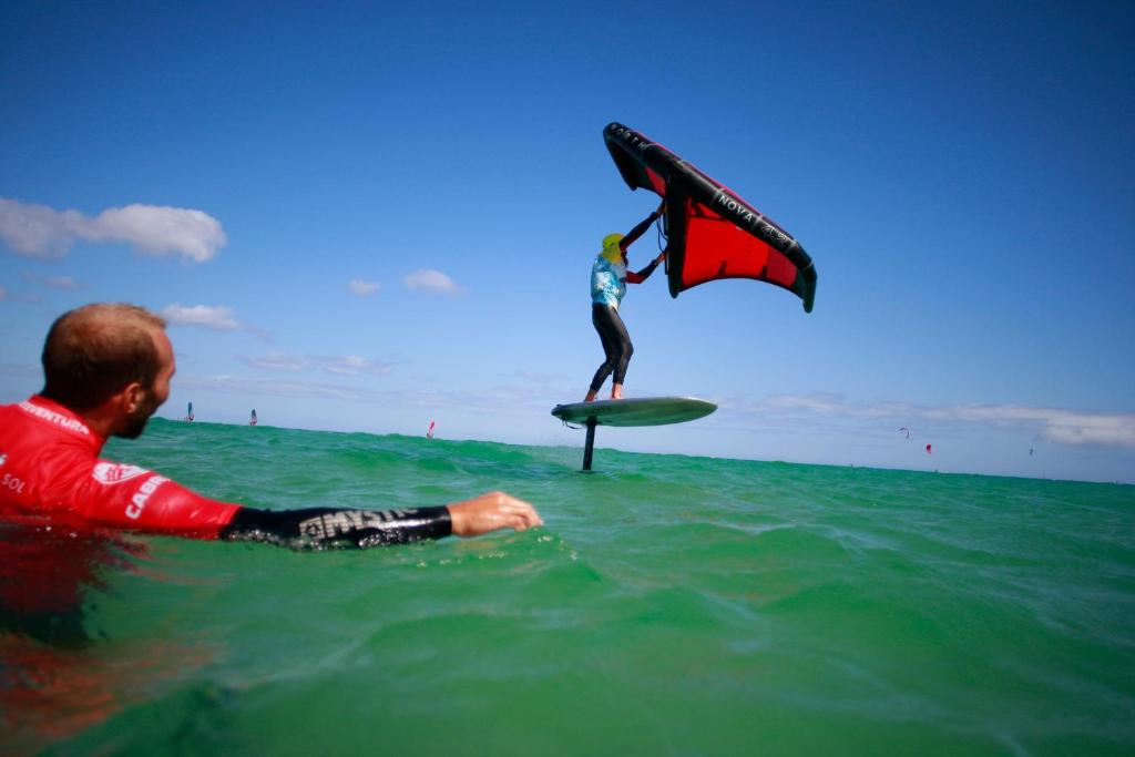 a man on a surfboard in the ocean with a kite at INNSiDE by Meliá Fuerteventura – Adults Only in Costa Calma