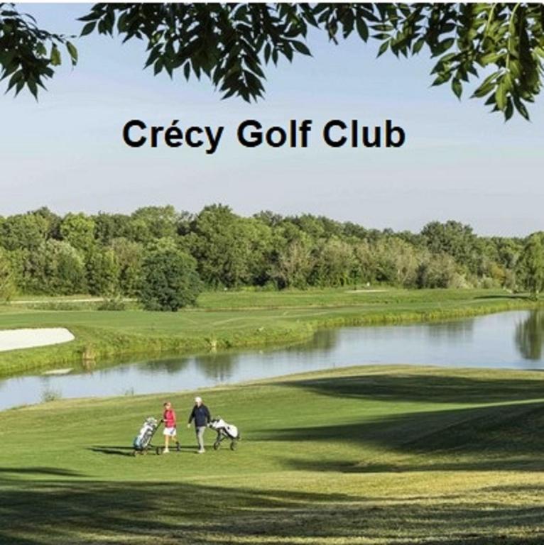 a group of people standing on a golf course at Les Nympheas, appart, grand jardin au calme, parking gratuit,15 min Disneyland, in Crécy-la-Chapelle