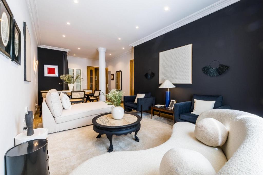 a living room with black walls and white furniture at ONDARRA Suite Apartment in San Sebastián