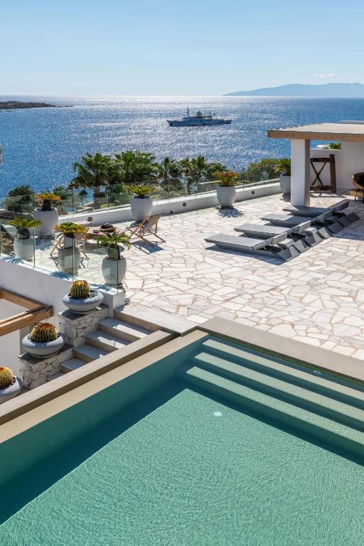 a swimming pool with a view of the ocean at Villa Lilium I - Overlooking Psarou Bay, Mykonos in Psarou
