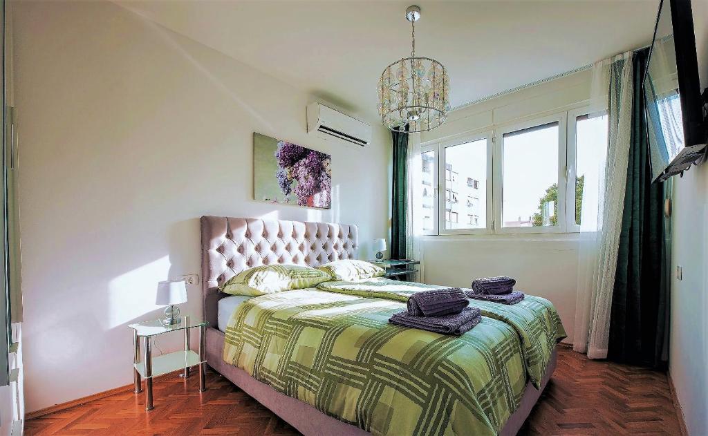 a bedroom with a bed and a chandelier at Madea Split in Split