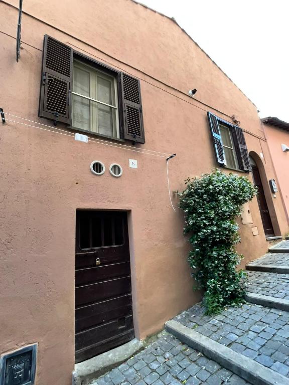 a brown building with a door and a window at Casa Valeria in Tuscania