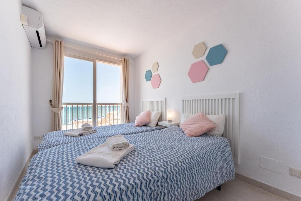 A bed or beds in a room at 4 bedroom beach Villa with direct access to the beach and private pool between Fuengirola and Marbella - Mijas costa