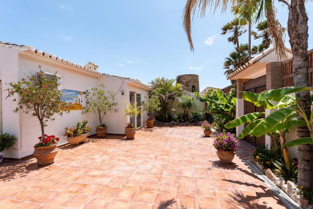 A garden outside 4 bedroom beach Villa with direct access to the beach and private pool between Fuengirola and Marbella - Mijas costa